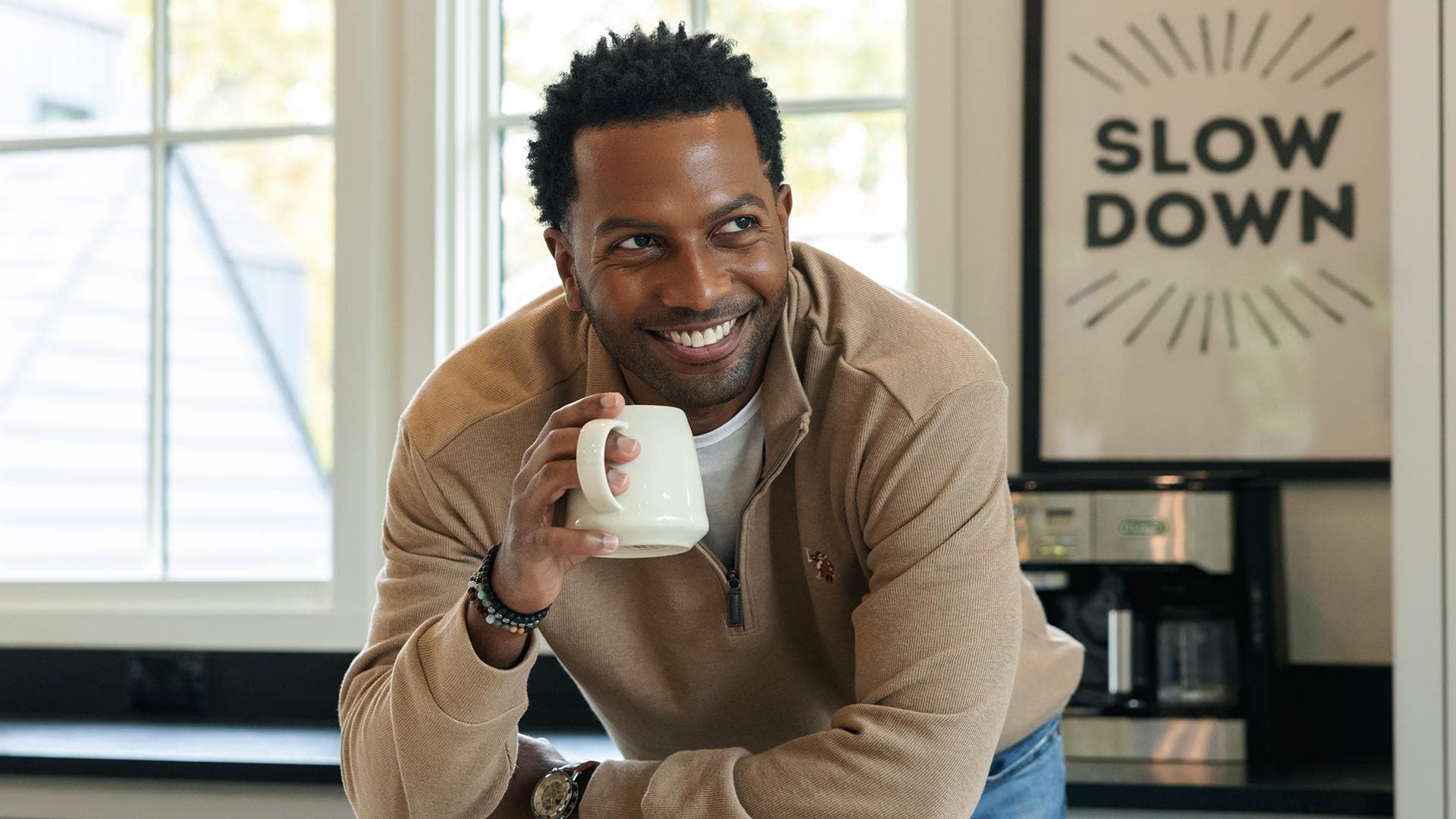 Interview subject Kevin drinking coffee in kitchen